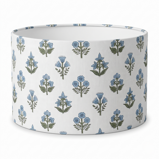 A drum lampshade featuring a delicate light blue and green floral sprig block print pattern on a crisp white background. This artisanal, nature-inspired piece perfectly adds a cozy modern rustic farmhouse aesthetic to Canadian and USA home decor.