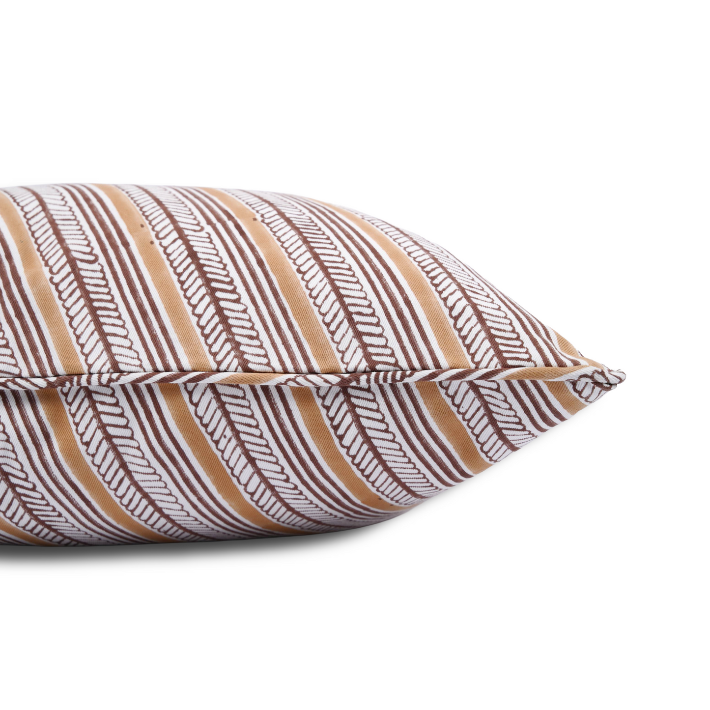 A close-up side view of the hand-block printed Serere Soil cushion lying flat on a white background. This shot highlights the neatly sewn, discreet hidden zipper closure and the distinctive pattern of diagonal bands in warm, earthy brown and terracotta tones. This handcrafted textile perfectly adds a cozy modern rustic Canadian farmhouse aesthetic to your home decor.