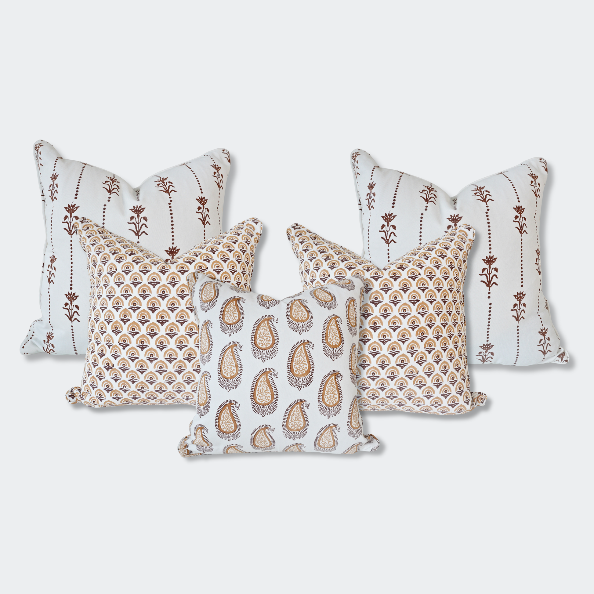 A curated set of five Homeway Living 100% cotton block-printed cushion covers on a light background. Features two back pillows with vertical brown floral motifs, two mid-layer pillows with an amber fan-arch pattern, and a front pillow with an amber paisley print. Finished with tailored piped edges, this artisan set offers a warm, high-end look ideal for modern rustic or Scandinavian home decor across Canada and the US.