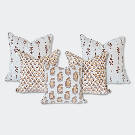 A curated set of five Homeway Living 100% cotton block-printed cushion covers on a light background. Features two back pillows with vertical brown floral motifs, two mid-layer pillows with an amber fan-arch pattern, and a front pillow with an amber paisley print. Finished with tailored piped edges, this artisan set offers a warm, high-end look ideal for modern rustic or Scandinavian home decor across Canada and the US.