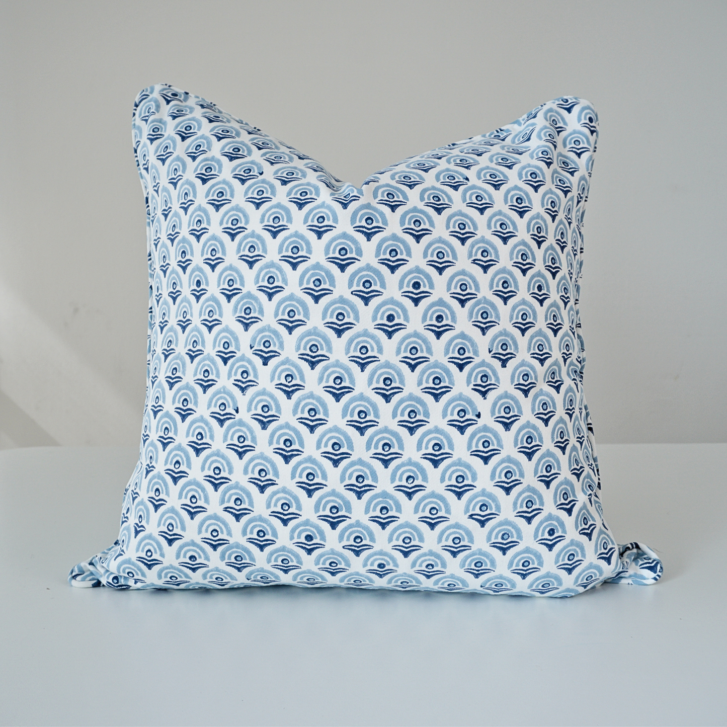 Square Arko Cerulean 100% cotton block printed pillow cover. This artisan throw cushion features a repeating small scalloped arch motif in cerulean blue and navy on a crisp white background with piped edges. Fine handmade textile home decor.