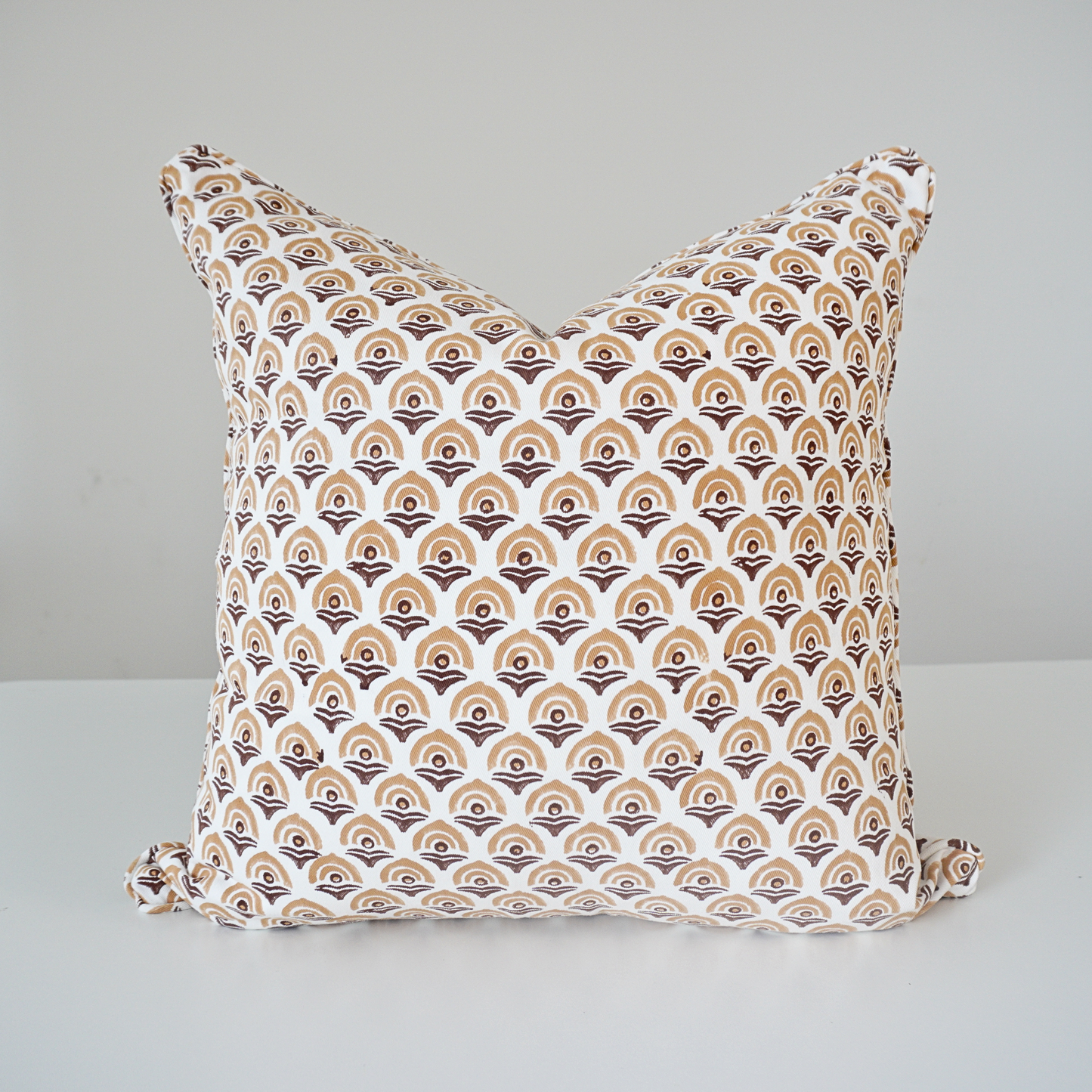 Square Arko Topaz 100% cotton block printed pillow cover. This artisan throw cushion features a repeating geometric arch-inspired pattern in warm brown and tan tones on a crisp white background, finished with tailored piped edges. Fine handmade artisan textile home decor.