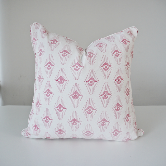 Studio product shot of a single Evia Blossom cushion cover, handcrafted from 100% cotton and centered on a white background. The design features a delicate, soft pink geometric arrow motif repeated on a crisp white base. Finished with elegant, tailored piped edges, this pillow showcases a high-end, artistic aesthetic by Homeway Living, suitable for contemporary living rooms or bedroom styling.