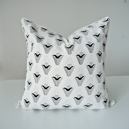 Studio product shot of a single Evia Charcoal cushion cover by Homeway Living, centered on a neutral background. Handcrafted from 100% cotton, it showcases a crisp white base patterned with a black and grey geometric arrow motif. Complete with tailored piped edges, this artisan piece offers a clean, high-end look ideal for modern rustic, Scandinavian, or contemporary living rooms.