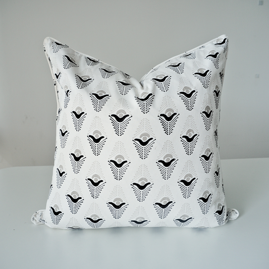 Studio product shot of a single Evia Charcoal cushion cover by Homeway Living, centered on a neutral background. Handcrafted from 100% cotton, it showcases a crisp white base patterned with a black and grey geometric arrow motif. Complete with tailored piped edges, this artisan piece offers a clean, high-end look ideal for modern rustic, Scandinavian, or contemporary living rooms.