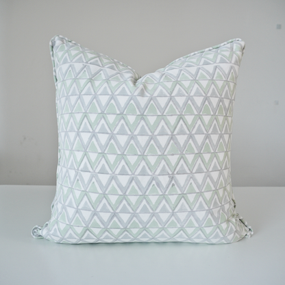 Square Moroccan Meadow Mist 100% cotton block printed pillow cover. This artisan throw cushion features a repeating geometric interlocking triangle pattern in soft meadow green and light grey on a crisp white background with tailored piped edges. Fine handmade textile home decor.