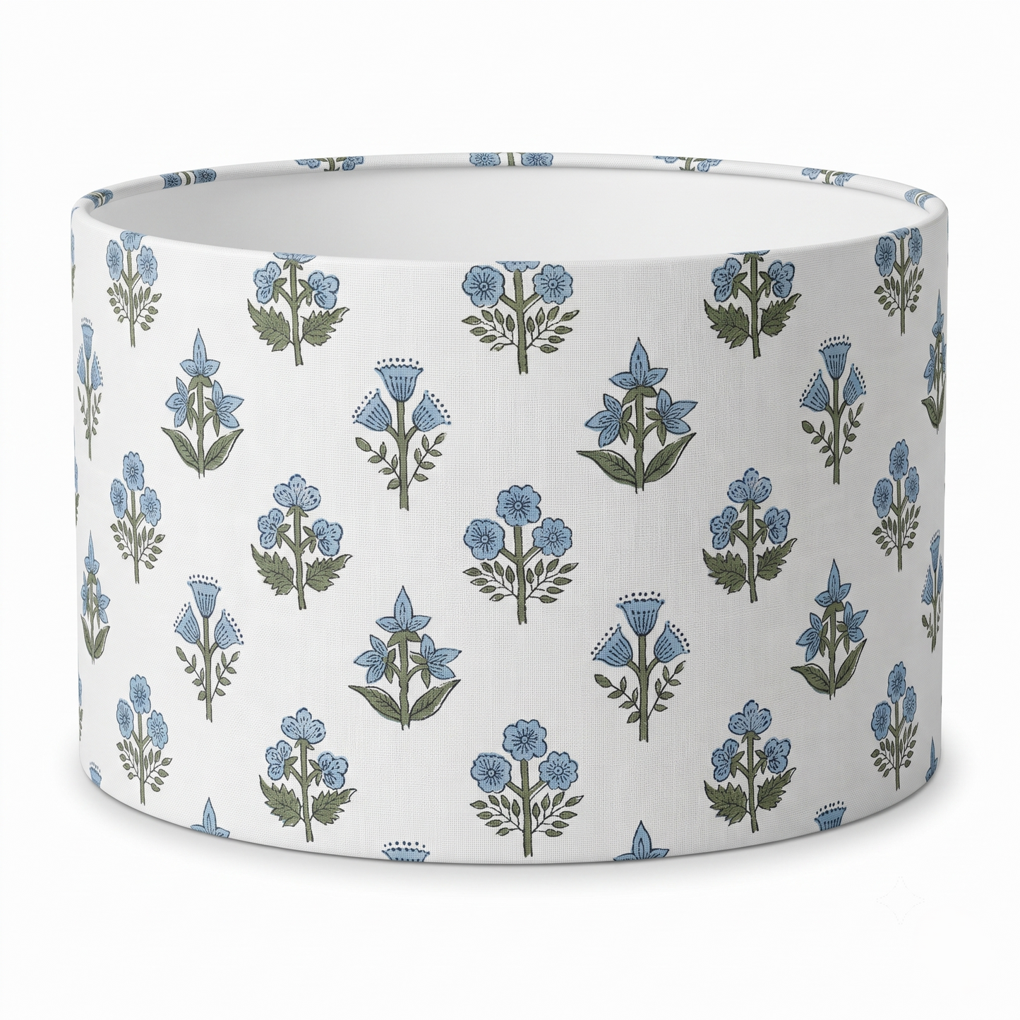 A drum lampshade featuring a delicate light blue and green floral sprig block print pattern on a crisp white background. This artisanal, nature-inspired piece perfectly adds a cozy modern rustic farmhouse aesthetic to Canadian and USA home decor.