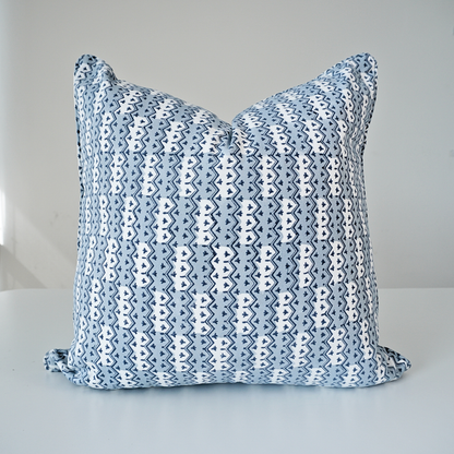 Studio product shot of a single Munnar Frost cushion cover by Homeway Living, centered on a neutral background. Handcrafted from 100% cotton, it features an intricate geometric chevron pattern in soft frost blue, navy, and white tones. Finished with tailored piped edges, this block-printed artisan piece offers a clean, high-end look ideal for modern rustic, coastal, or Scandinavian interiors.
