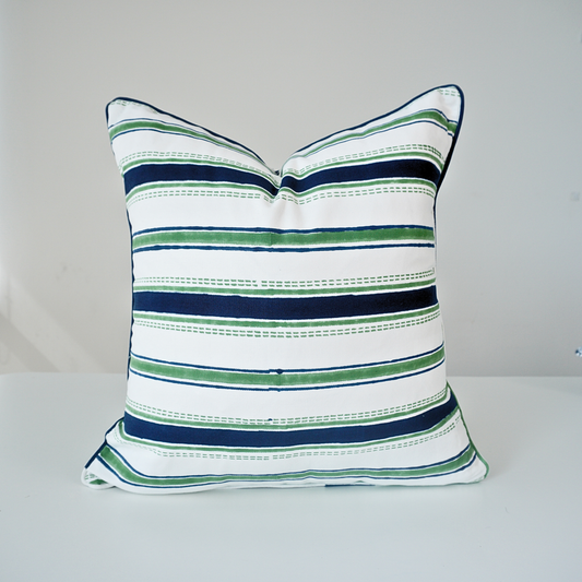 Square Orai Indigo 100% cotton block printed pillow cover. This artisan throw cushion features a classic horizontal stripe pattern in deep indigo blue and fresh green with dashed line details on a crisp white background with piped edges. Fine handmade textile home decor.