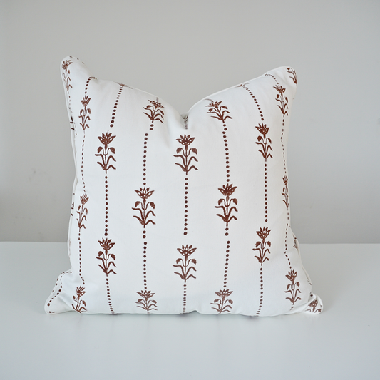 Square Reed Soil 100% cotton block printed pillow cover. This artisan throw cushion features a repeating earthy brown vertical dotted stripe and floral botanical motif on a crisp white background with tailored piped edges. Fine handmade textile home decor.