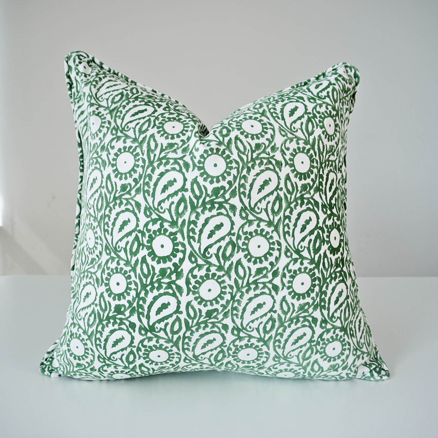Square Siona Scallion 100% cotton block printed pillow cover. This artisan throw cushion features an intricate green paisley and floral botanical motif on a crisp white background with piped edges. Fine handmade textile home decor.
