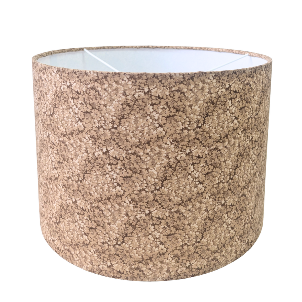 A classic drum lampshade featuring the Penny Ditsy pattern, showcasing a delicate and dense earthy brown micro-floral print. This warm, contemporary piece perfectly adds a cozy, modern Canadian farmhouse aesthetic to any room's decor.
