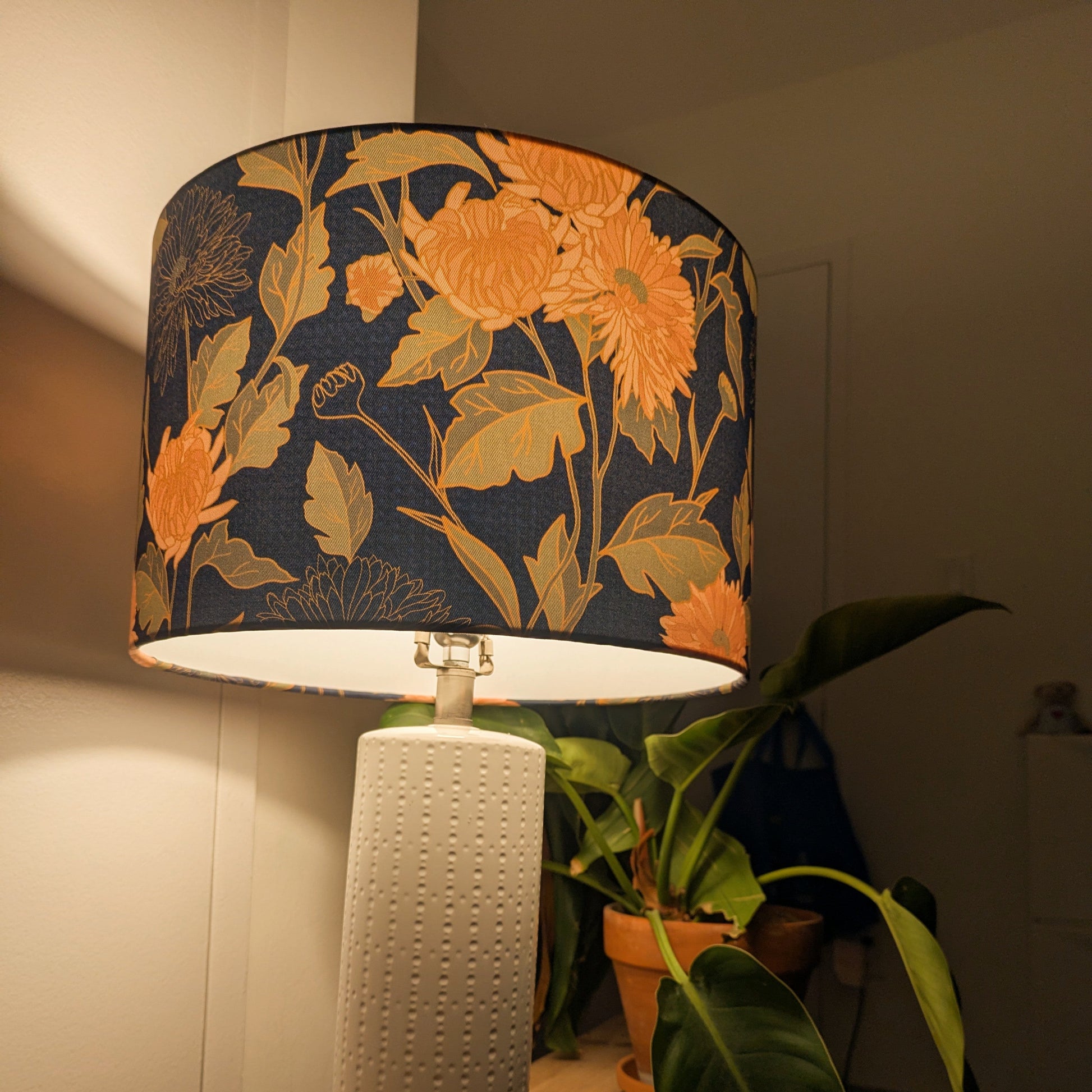 Lamp with floral-patterned shade with warm light