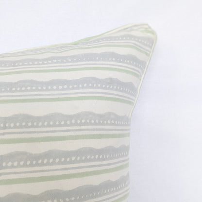 A close-up corner view of the "Amalfi Breeze" hand-block printed cushion, highlighting its refreshing sage green and light blue horizontal striped and wavy pattern on a crisp white background. This detail shot emphasizes the clean, piped edges, showcasing the quality of this handcrafted textile that perfectly adds a cozy modern rustic Canadian farmhouse aesthetic to any home decor.