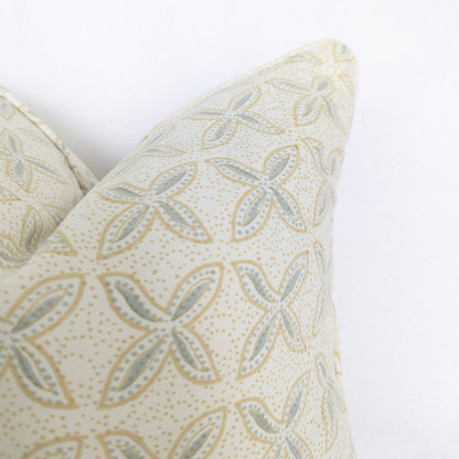 A close-up corner view of the hand-block printed Bali plumeria Breeze cushion against a crisp white background. This detail highlights the clean, piped edges and the delicate soft blue and tan floral geometric pattern. This beautifully handcrafted textile perfectly adds a light, cozy modern rustic Canadian farmhouse aesthetic to your home decor.