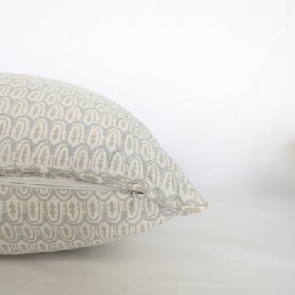 Pale blue and beige hand-block printed cushion cover held up in bright natural light. The close-up showcases a delicate geometric pattern on natural cotton fabric, perfect for a modern Canadian rustic or farmhouse home decor aesthetic.