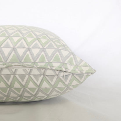 Close-up side view showing the hidden zipper closure and piped seam of the Moroccan Meadow Mist 100% cotton block printed pillow and cushion cover. Features a repeating geometric interlocking triangle pattern in soft meadow green and light grey on white fabric against a clean white background. Fine handmade artisan textile home decor.