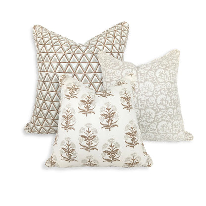 A beautifully curated trio of hand-block printed cushions against a crisp white background. The collection features an earthy tan and soft grey geometric triangle pattern, an elegant soft grey botanical design, and a coordinating tan floral motif in the front. These handcrafted textiles perfectly add a light, airy, and cozy modern rustic Canadian farmhouse aesthetic to any home decor.