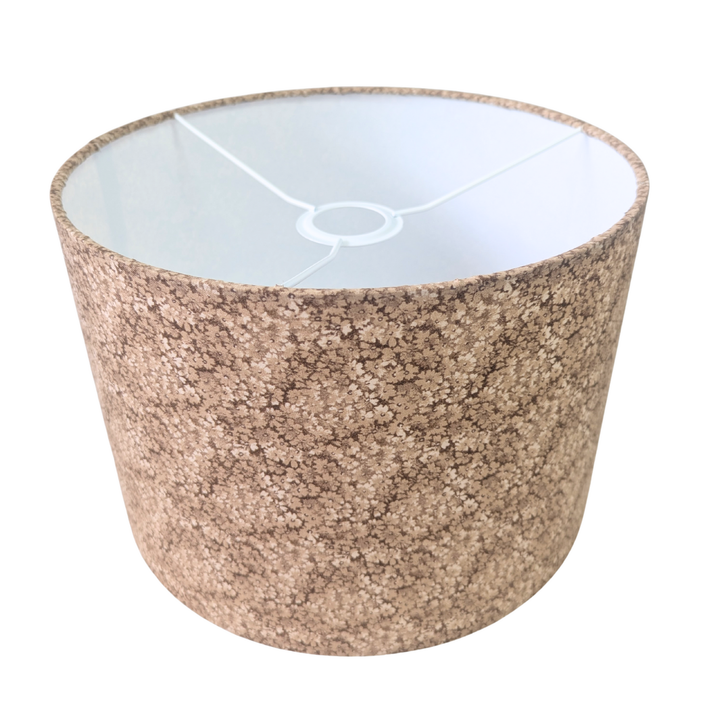 A top-down angled view of a drum lampshade showcasing the white interior lining and top metal spider fitting. The exterior features the Penny Ditsy pattern, a delicate earthy brown micro-floral print. This warm piece perfectly adds a cozy modern Canadian farmhouse aesthetic to any home decor.