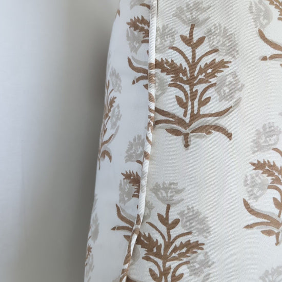 A close-up video detailing an earthy brown and soft beige floral sprig hand-block printed cushion cover. The footage highlights the neat edge finishing and delicate artisanal craftsmanship on natural fabric. This inviting textile perfectly adds a sophisticated modern rustic farmhouse style to Canadian and USA homes.
