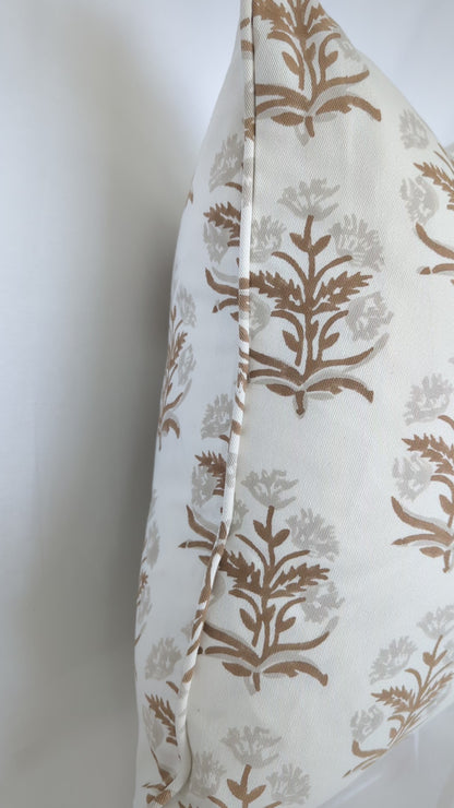 A close-up video detailing an earthy brown and soft beige floral sprig hand-block printed cushion cover. The footage highlights the neat edge finishing and delicate artisanal craftsmanship on natural fabric. This inviting textile perfectly adds a sophisticated modern rustic farmhouse style to Canadian and USA homes.