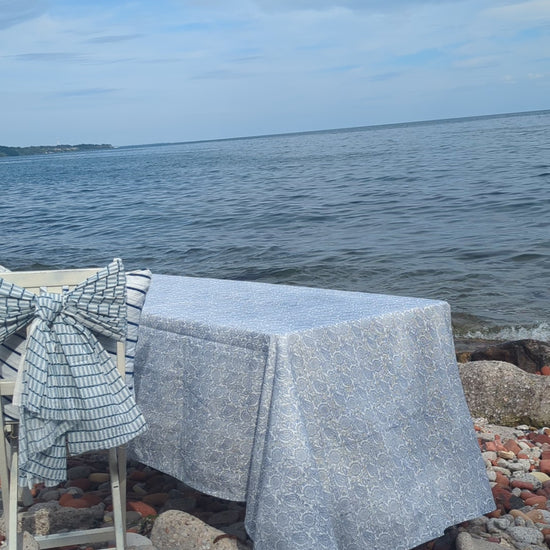 Blue block printed table linen table set at the shore near the lake