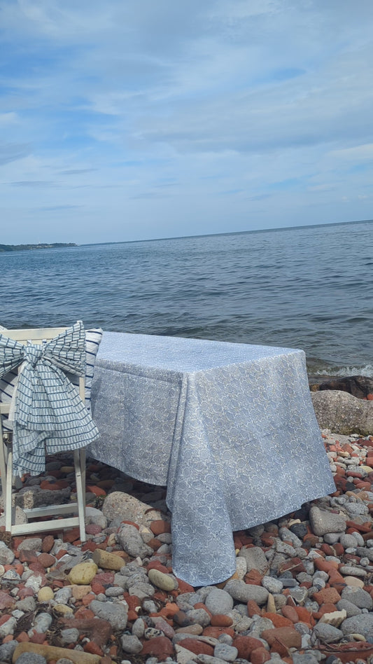 Blue block printed table linen table set at the shore near the lake