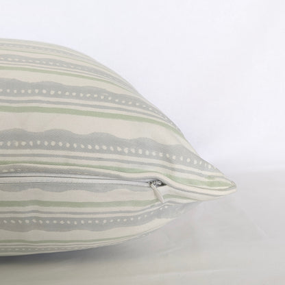 A close-up side view of the "Amalfi Breeze" hand-block printed cushion, showcasing its refreshing sage green and light blue horizontal striped and wavy pattern on a crisp white background. This detail shot highlights the neatly sewn, discreet hidden zipper closure, emphasizing the quality of this handcrafted textile that perfectly adds a cozy modern rustic Canadian farmhouse aesthetic to any home decor.