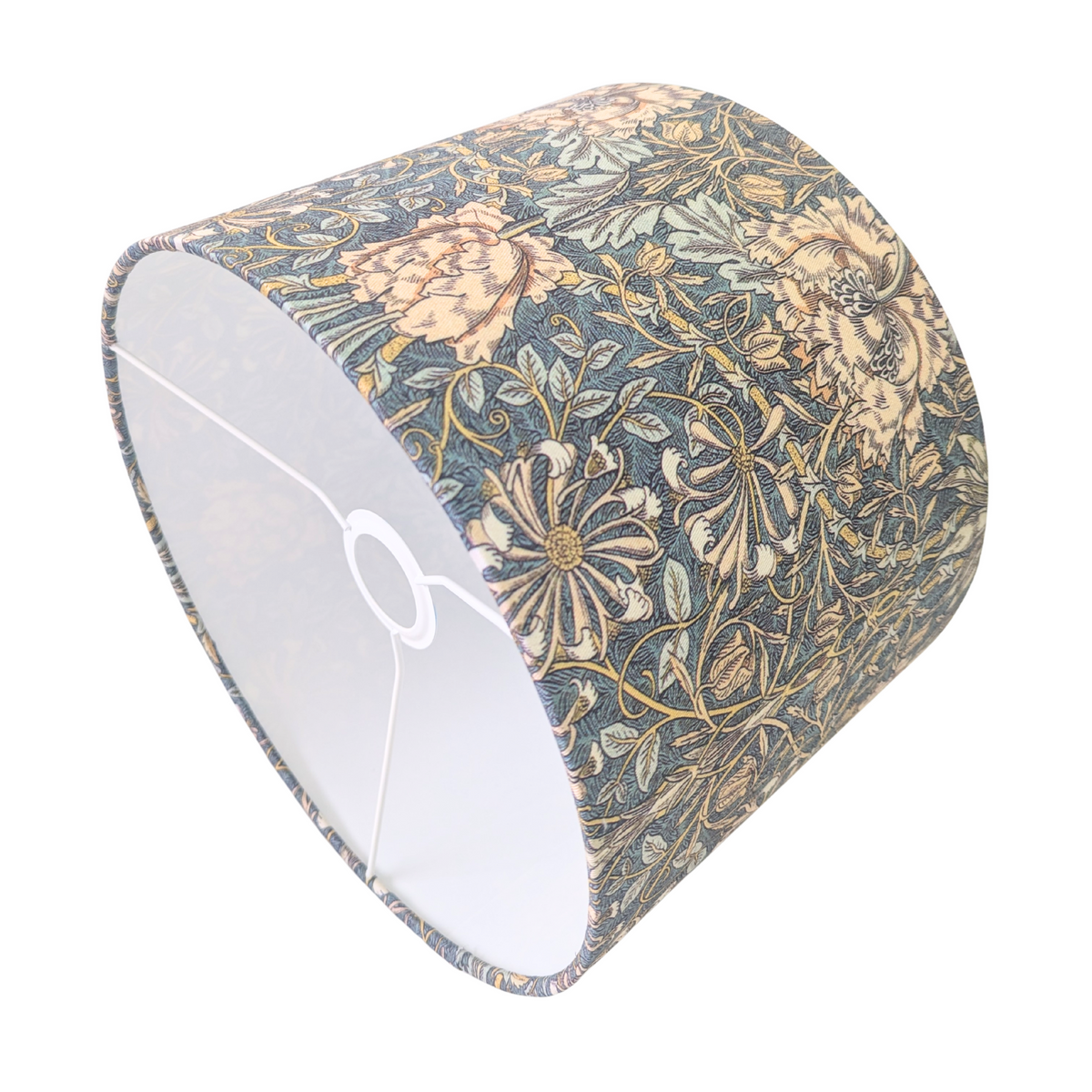 An angled interior view of a drum lampshade showcasing the white lining and metal spider fitting. The exterior features the classic William Morris Honeysuckle botanical pattern with peach flowers and green foliage on a dark background. This vintage-style piece beautifully complements a cozy modern rustic farmhouse aesthetic for Canadian and USA home decor.